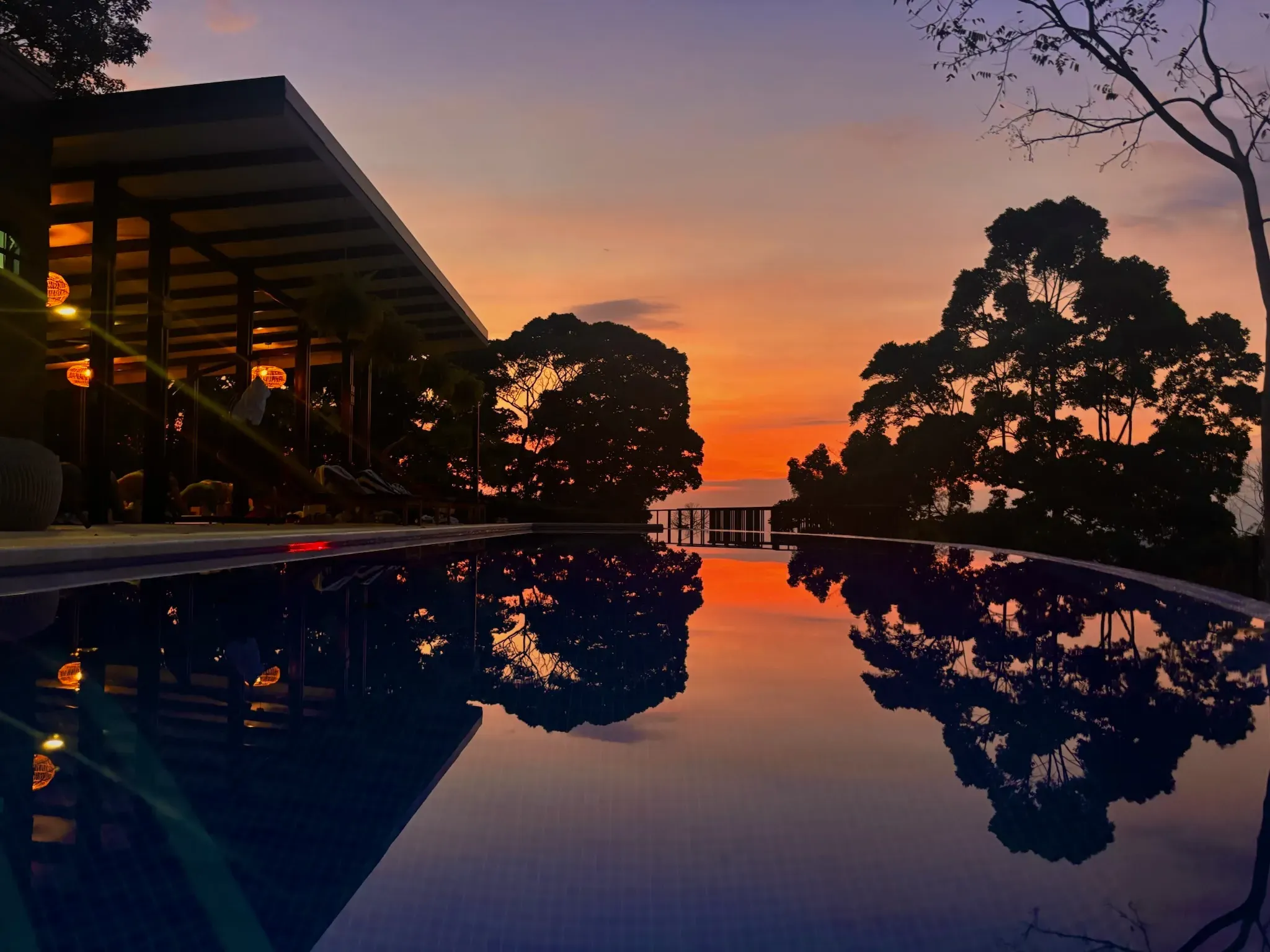 The infinity pool and coast at golden hour